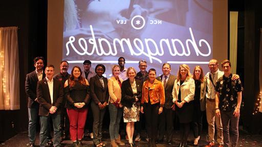 学生 and faculty posing on stage at the Changemaker Challenge.